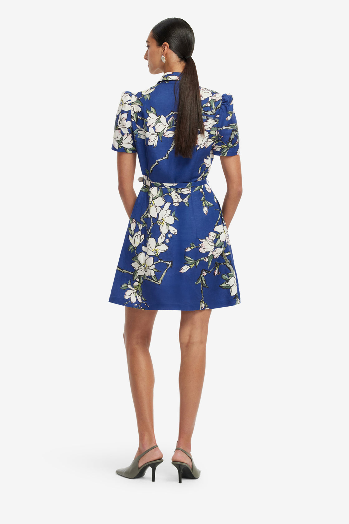 Woman wearing a blue floral dress on a white background