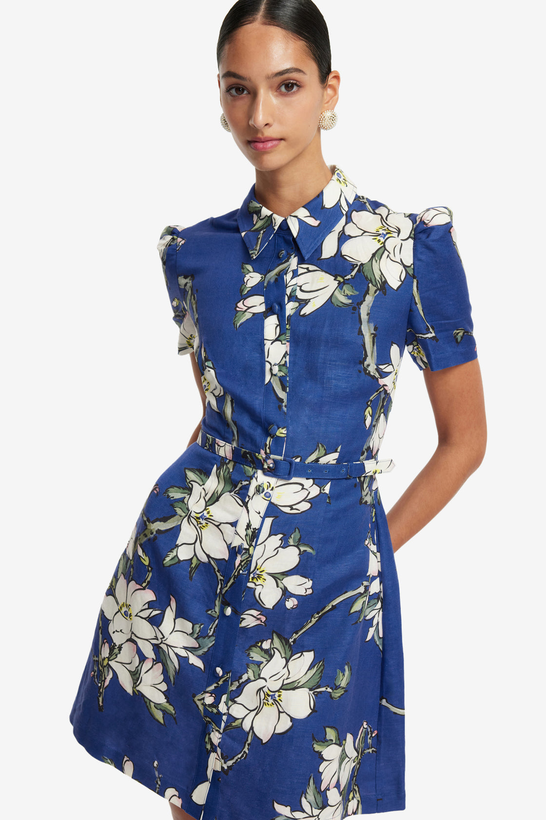Woman wearing a blue floral dress on a white background