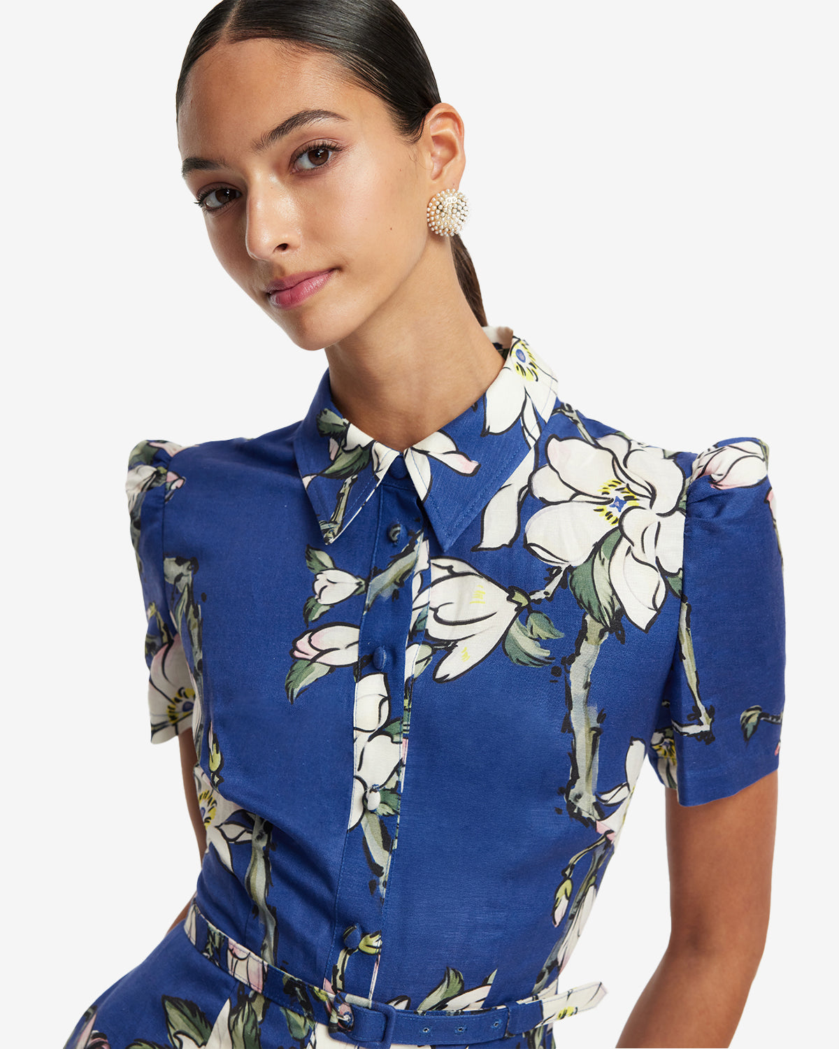 Woman wearing a blue floral dress on a white background