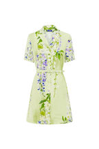 A cascading lilac dream! These beautiful lilac wisteria blooms tumble down a soft lime canvas. This print evokes pure fresh air, and feels like floating through a tranquil, sun-drenched garden on the first day of spring.

Premium linen blend mini dress
Exclusive LEO LIN Wisteria Print
Collared neckline
Short sleeves
Front button opening
A-line mini skirt
Matching belt included