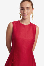 Woman wearing a red dress with a plain background