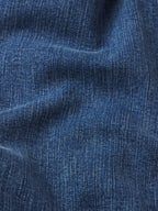 Close-up of blue denim fabric with visible texture