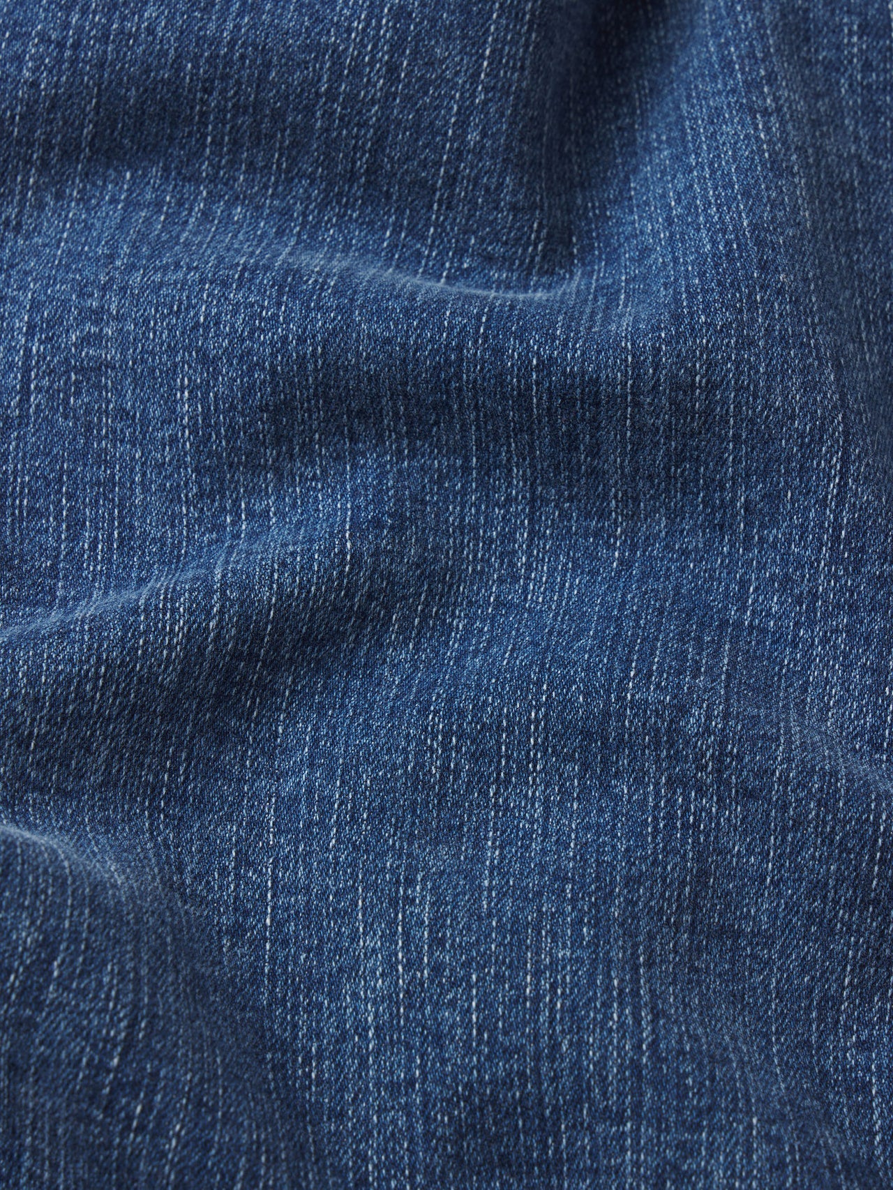 Close-up of blue denim fabric with visible texture