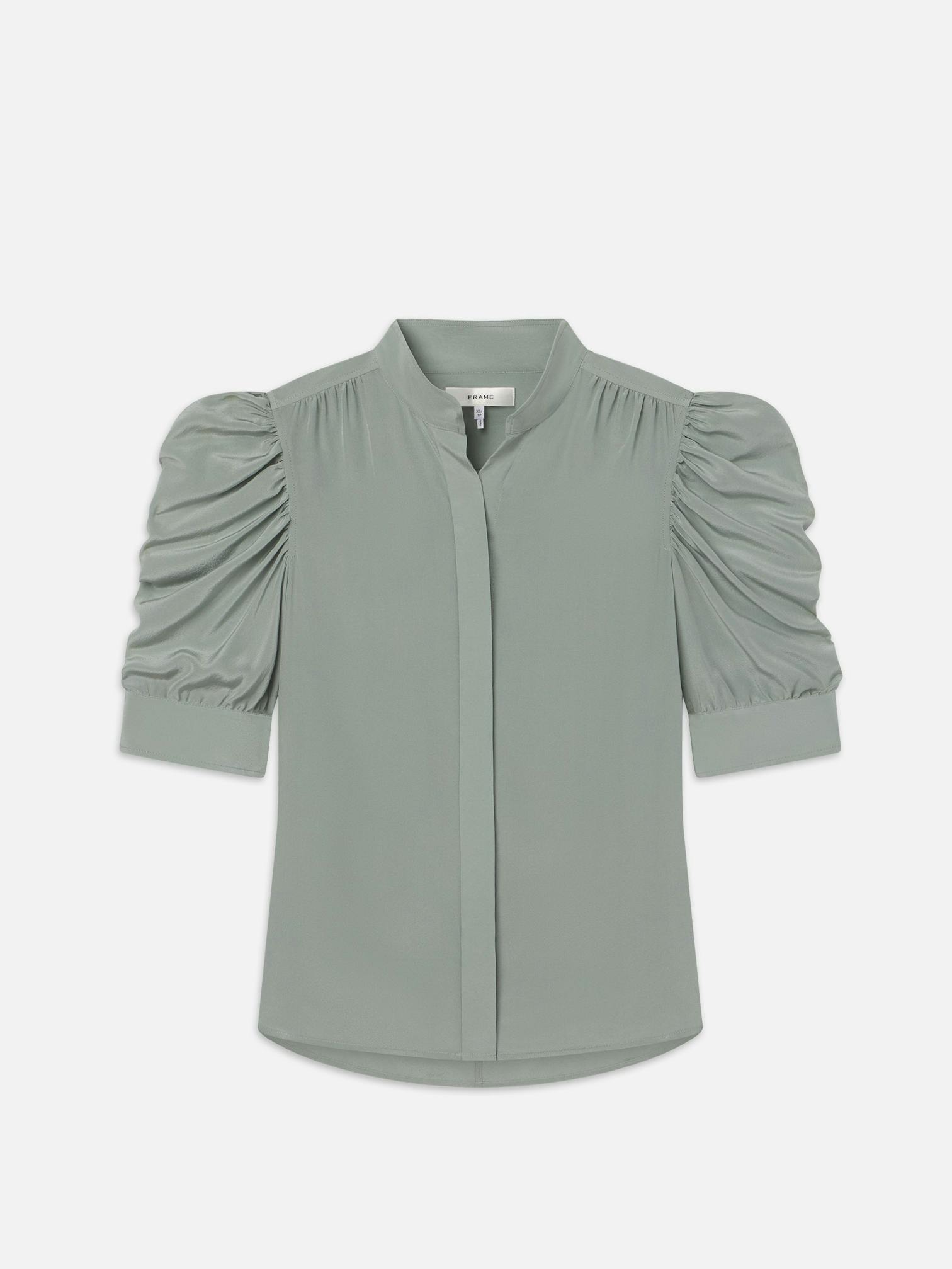 A sage green, short-sleeved, button-up shirt with ruffled detailing at the sleeves.