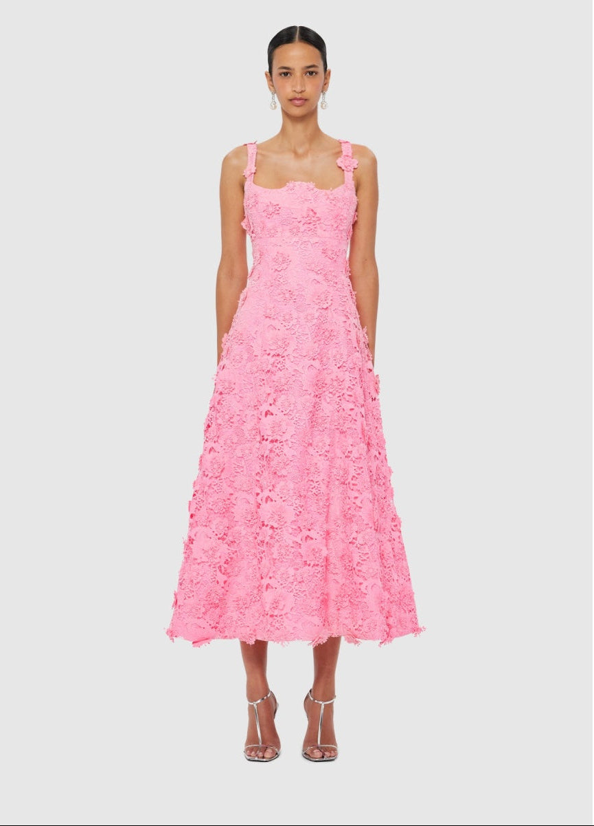 Woman wearing a pink floral dress on a light gray background