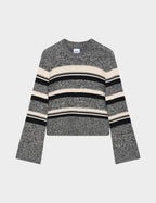 Striped sweater with black, beige, and gray pattern on a light gray background