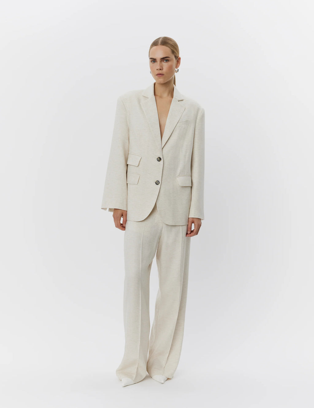 Woman wearing a beige suit on a white background