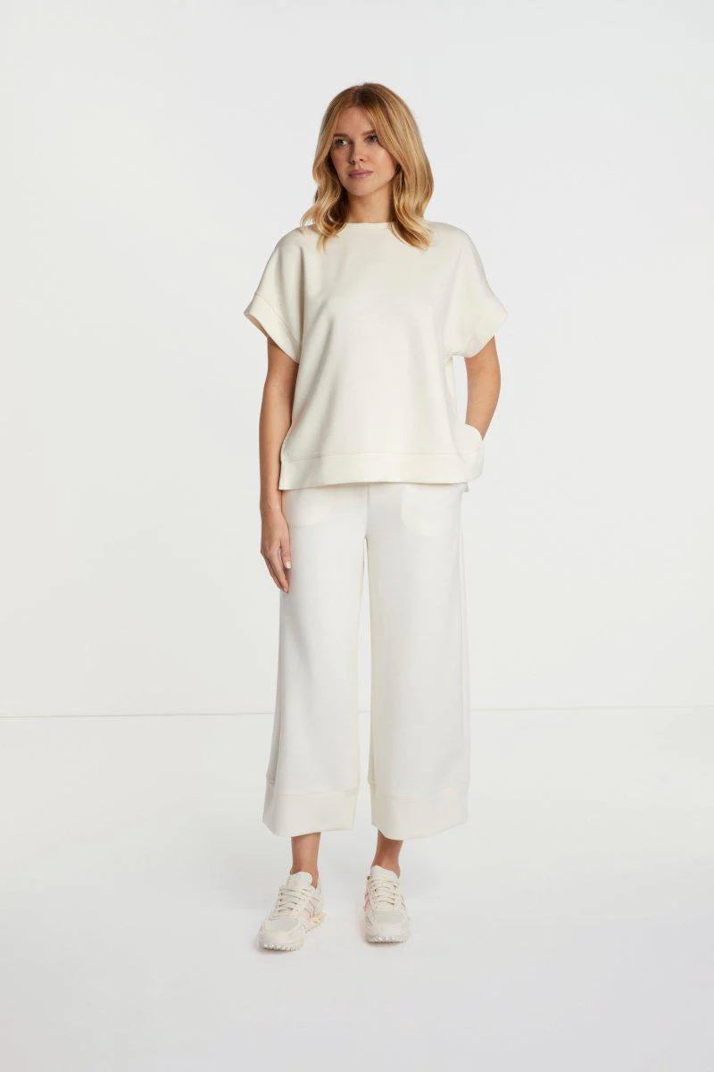 Woman wearing a rich and royal white outfit on a white background shop online muse boutique hawthorn
