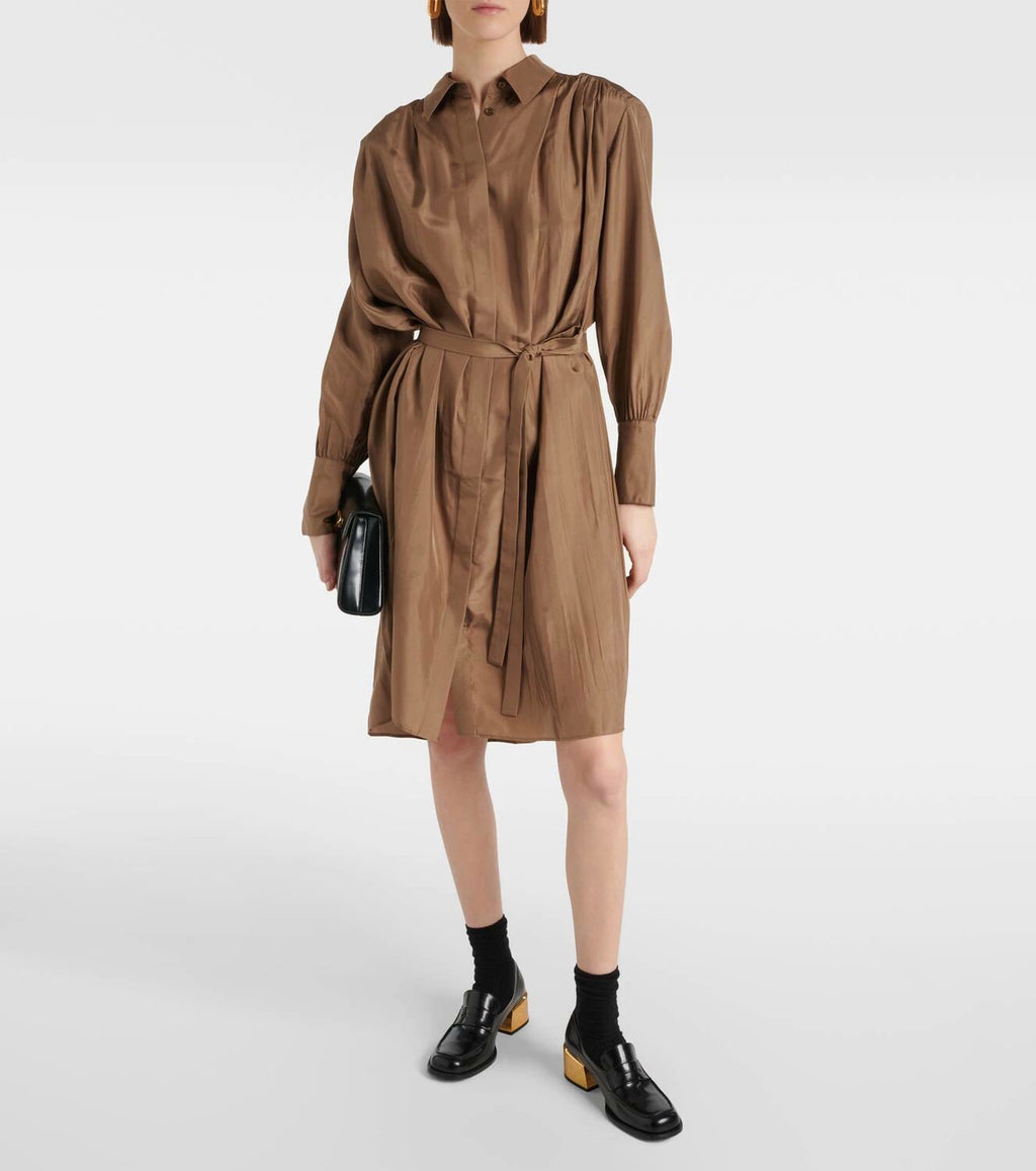 Person wearing a brown dress with a belt on a white background