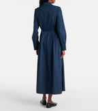 Navy blue dress worn by a person on a white background