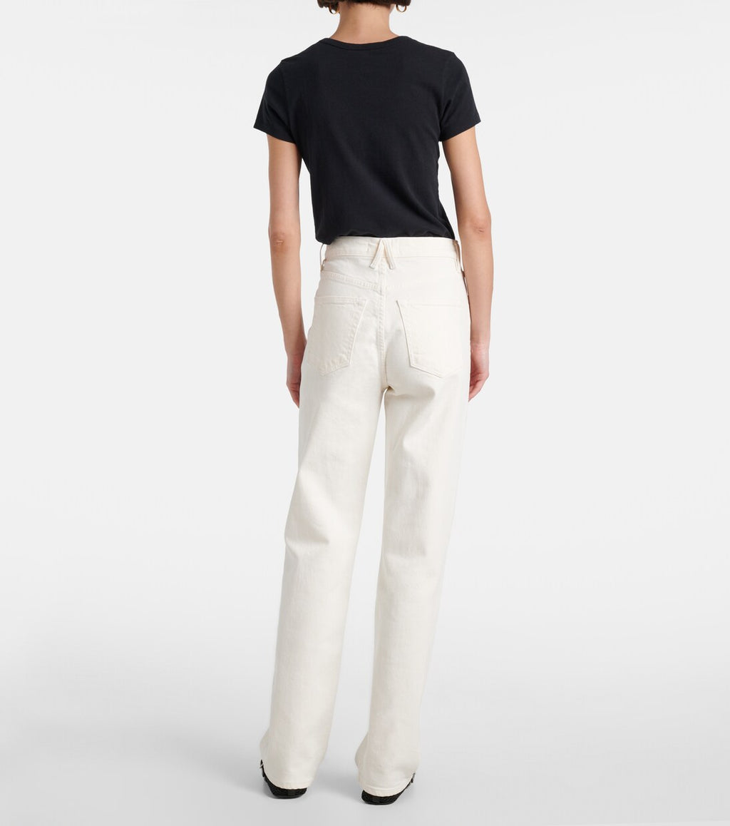 Person wearing a black t-shirt and white pants on a plain background