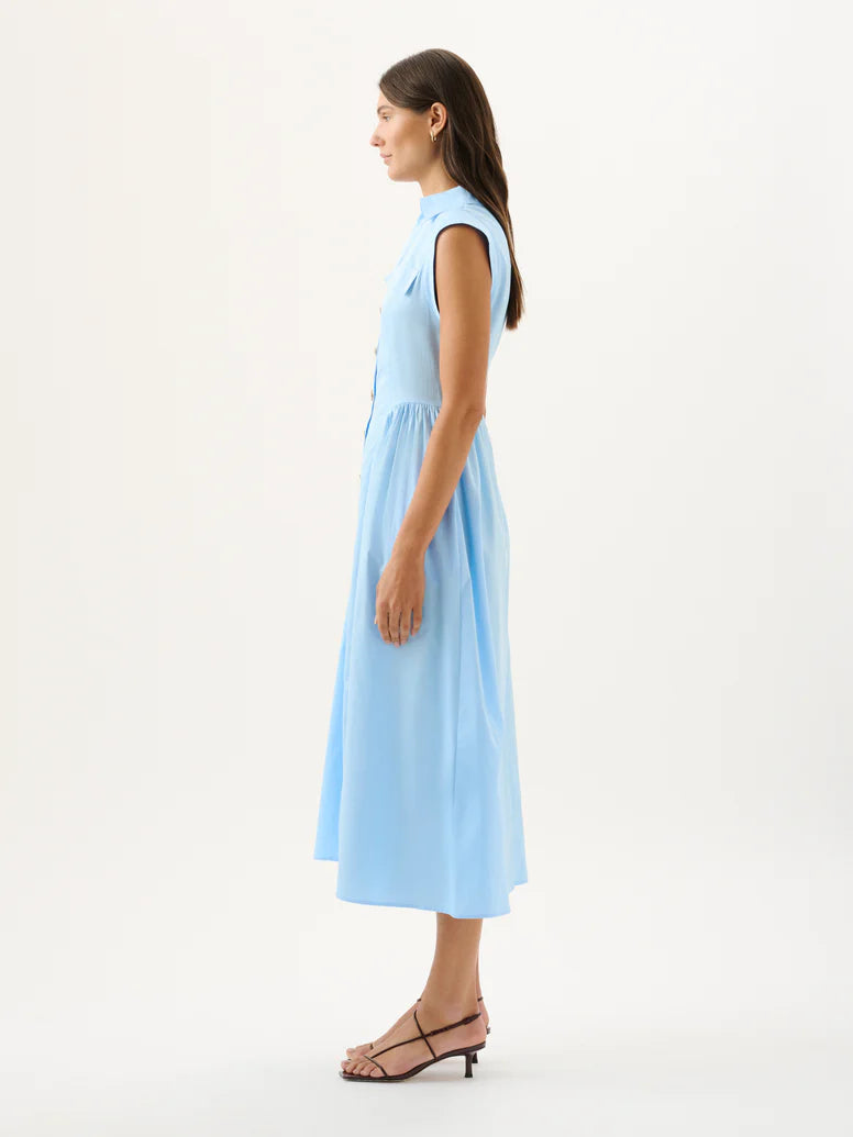 Woman wearing a light blue dress on a white background