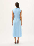 Woman wearing a light blue dress on a white background