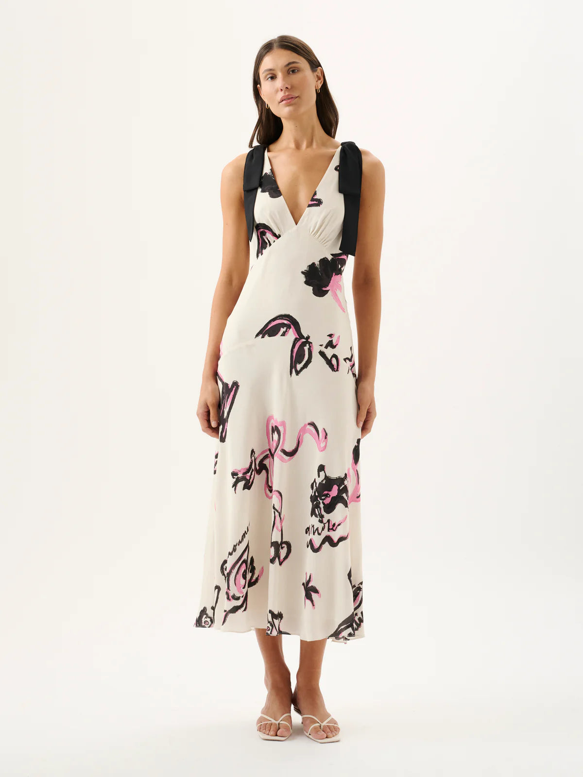Woman wearing a floral dress with suspenders on a white background