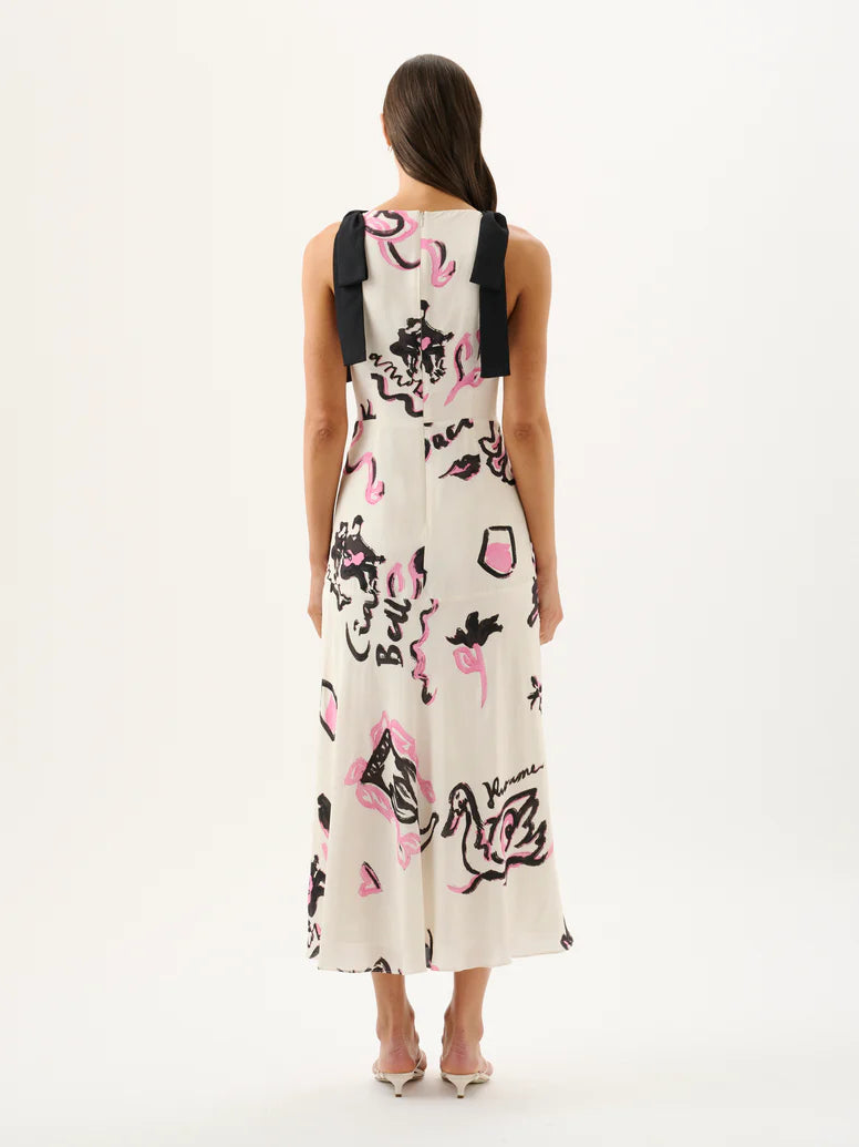 Woman wearing a sleeveless dress with abstract black and pink designs on a white background