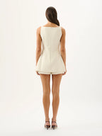 Woman wearing a white sleeveless dress on a white background