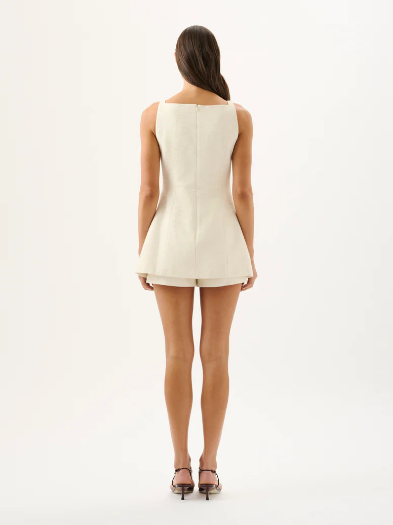 Woman wearing a white sleeveless dress on a white background