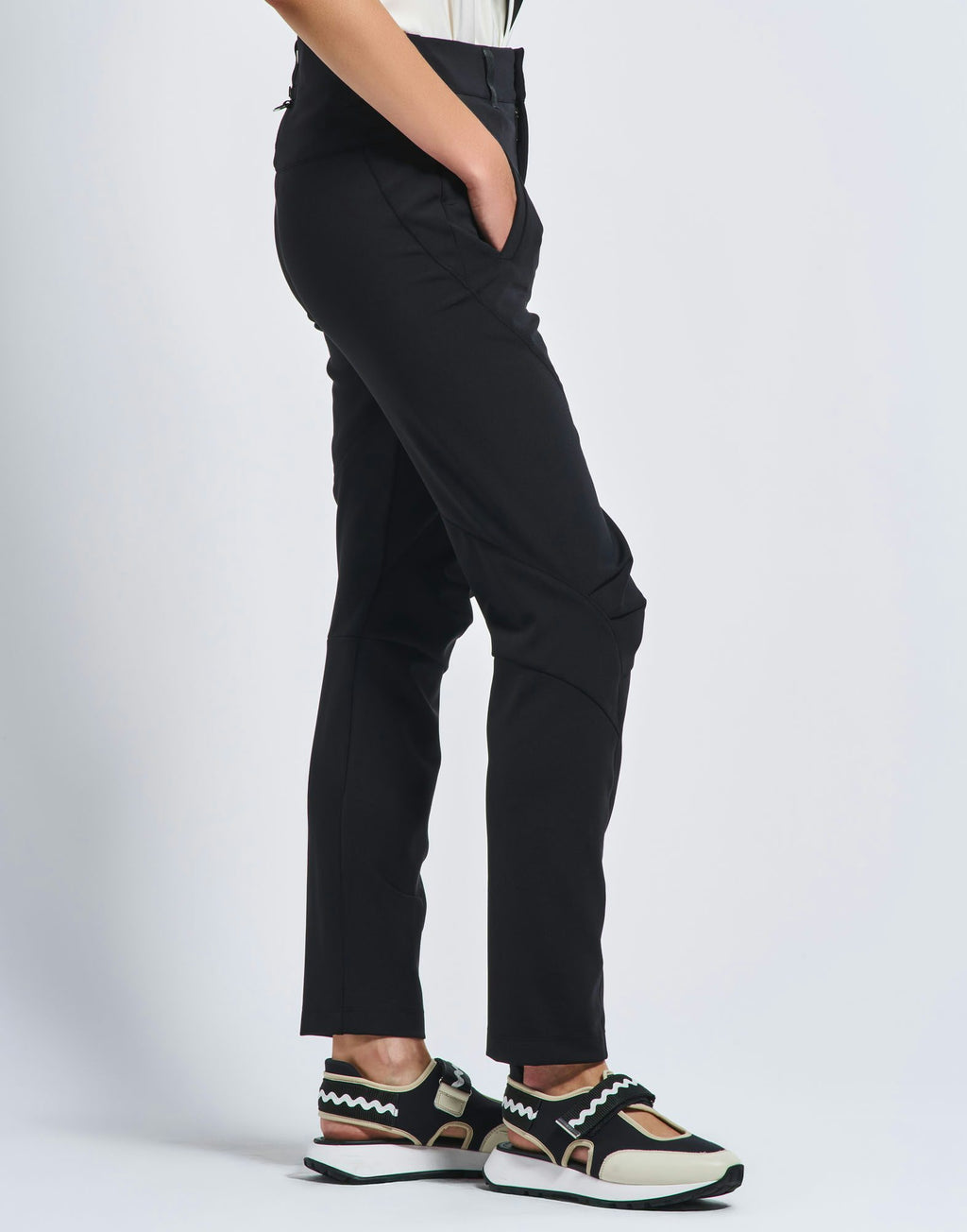 Person wearing black pants on a white background