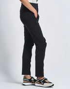 Person wearing black pants on a white background