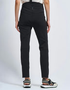 Black pants worn by a person on a white background