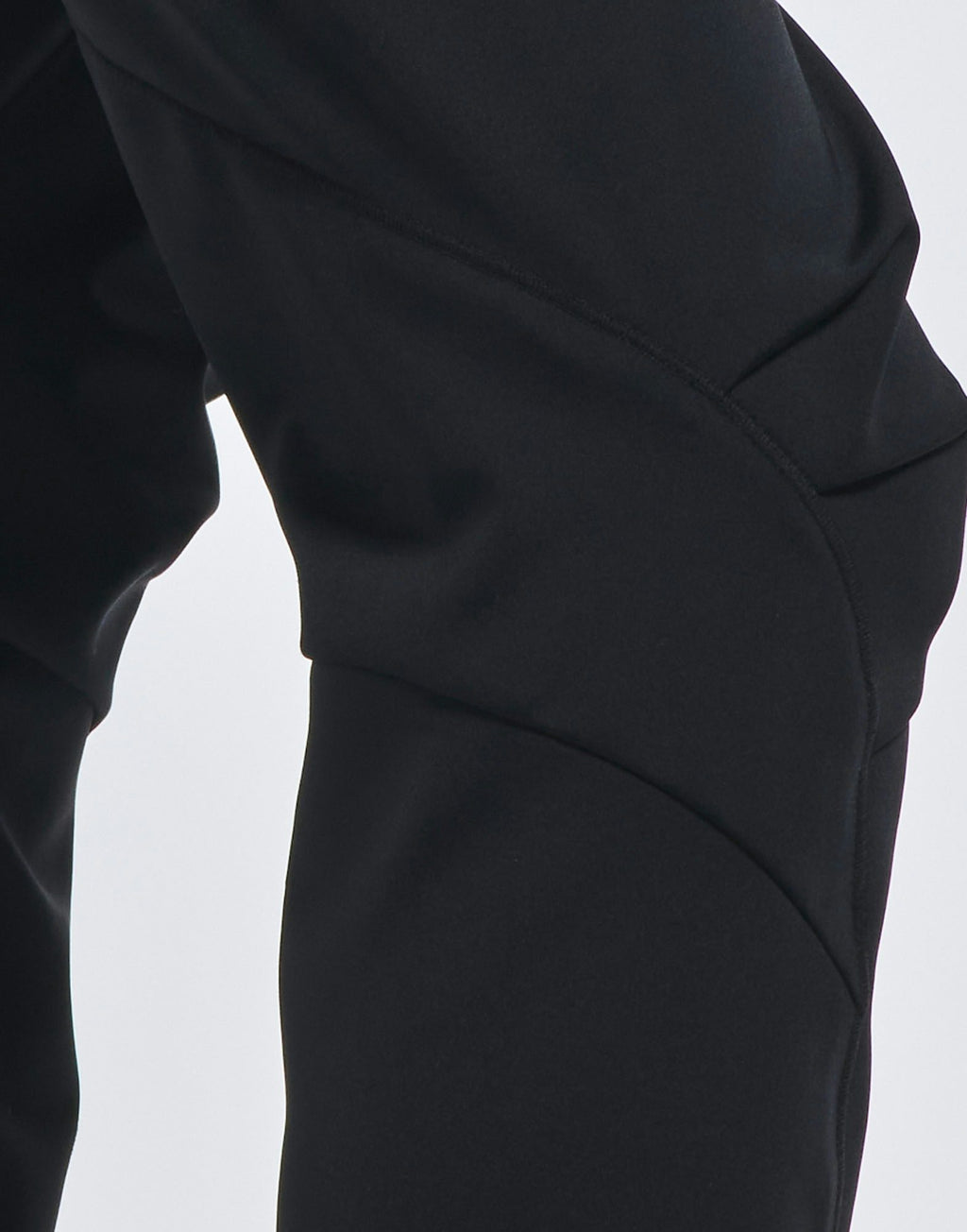 Close-up of black pants on a white background