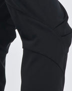 Close-up of black pants on a white background