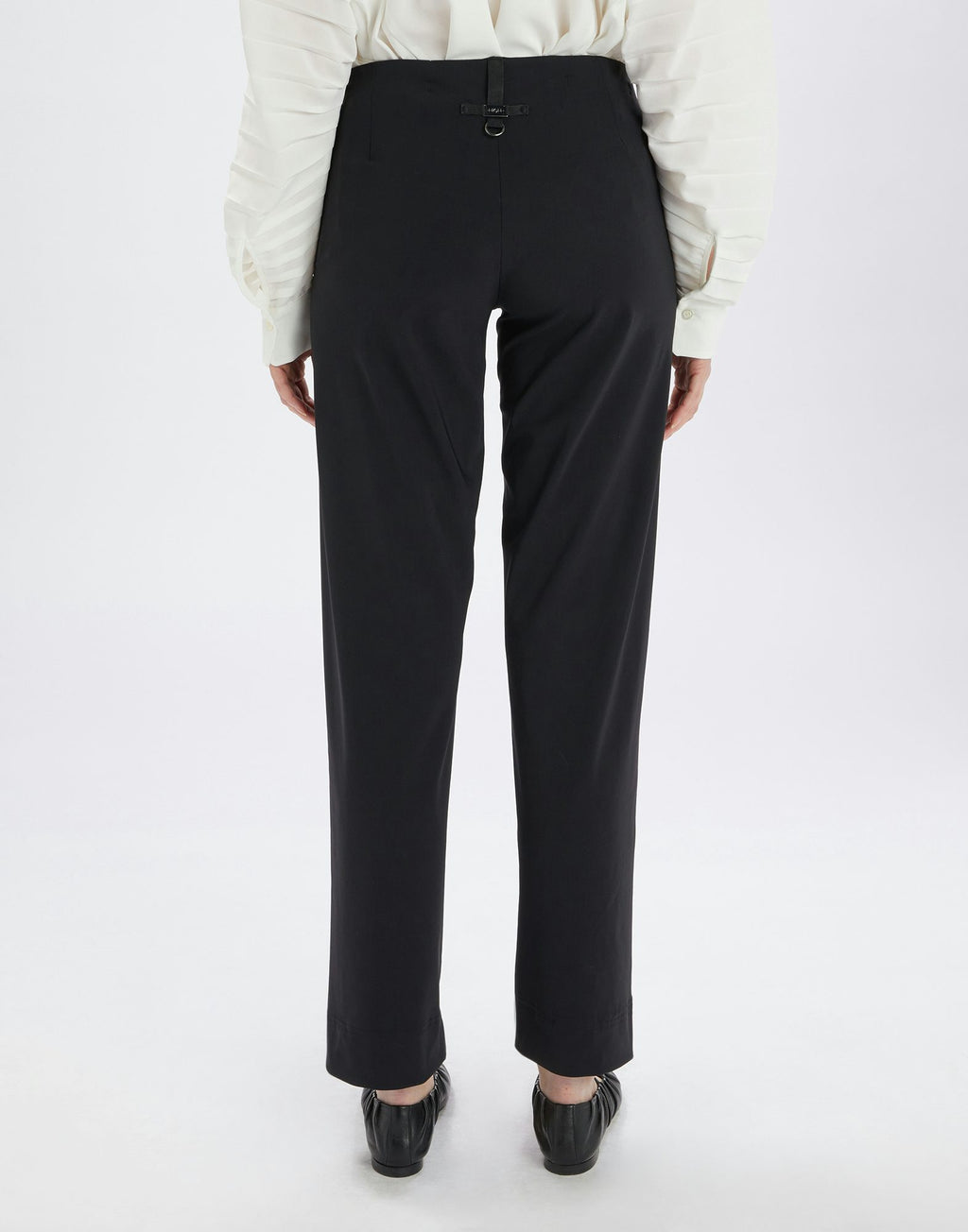 Black pants worn by a person on a white background