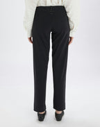 Black pants worn by a person on a white background