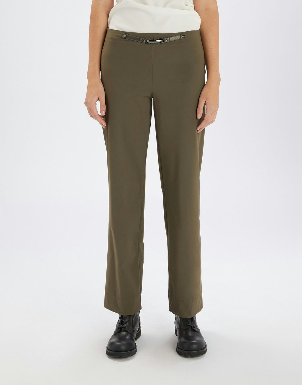 Person wearing olive green pants on a white background