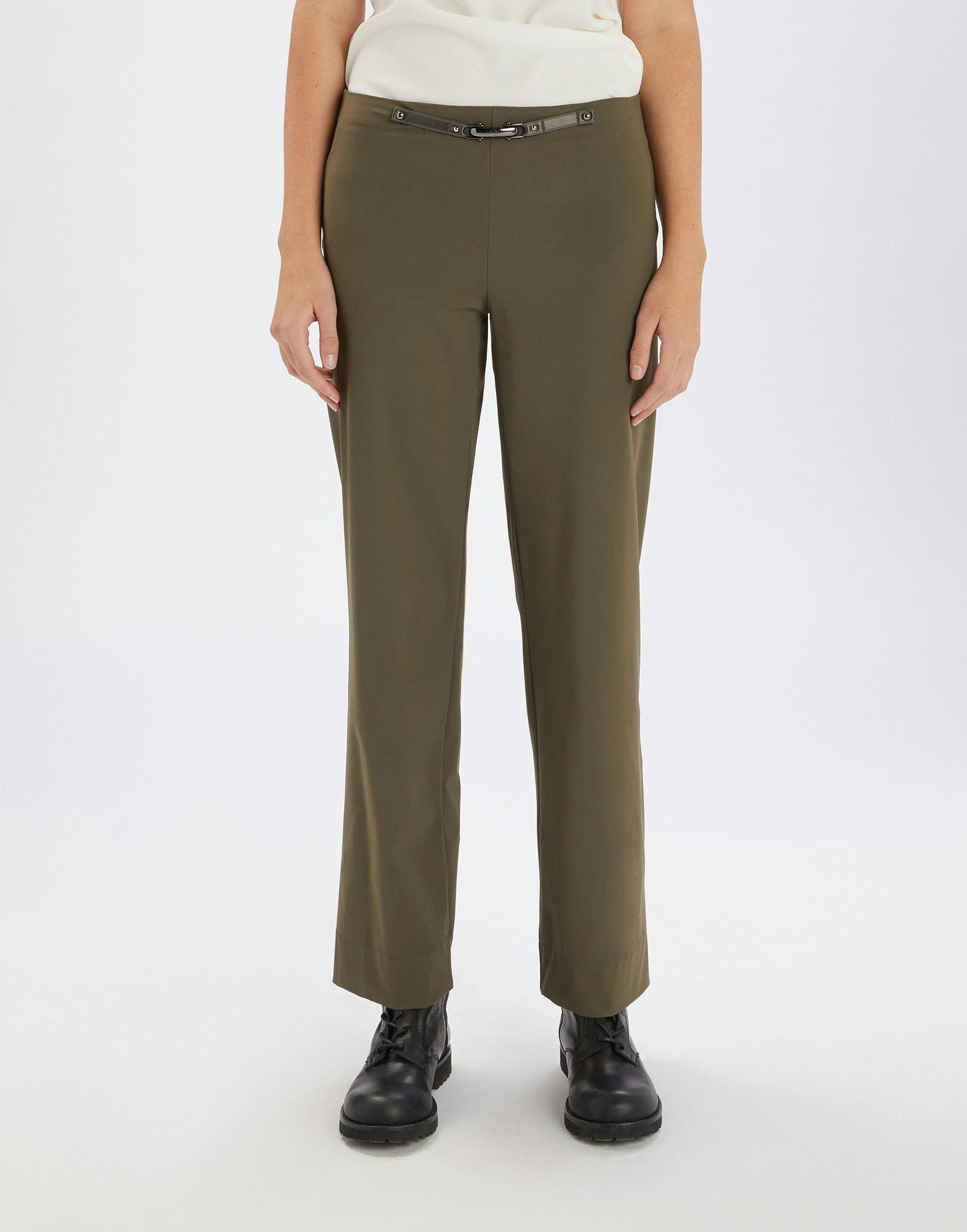 Person wearing olive green pants on a white background