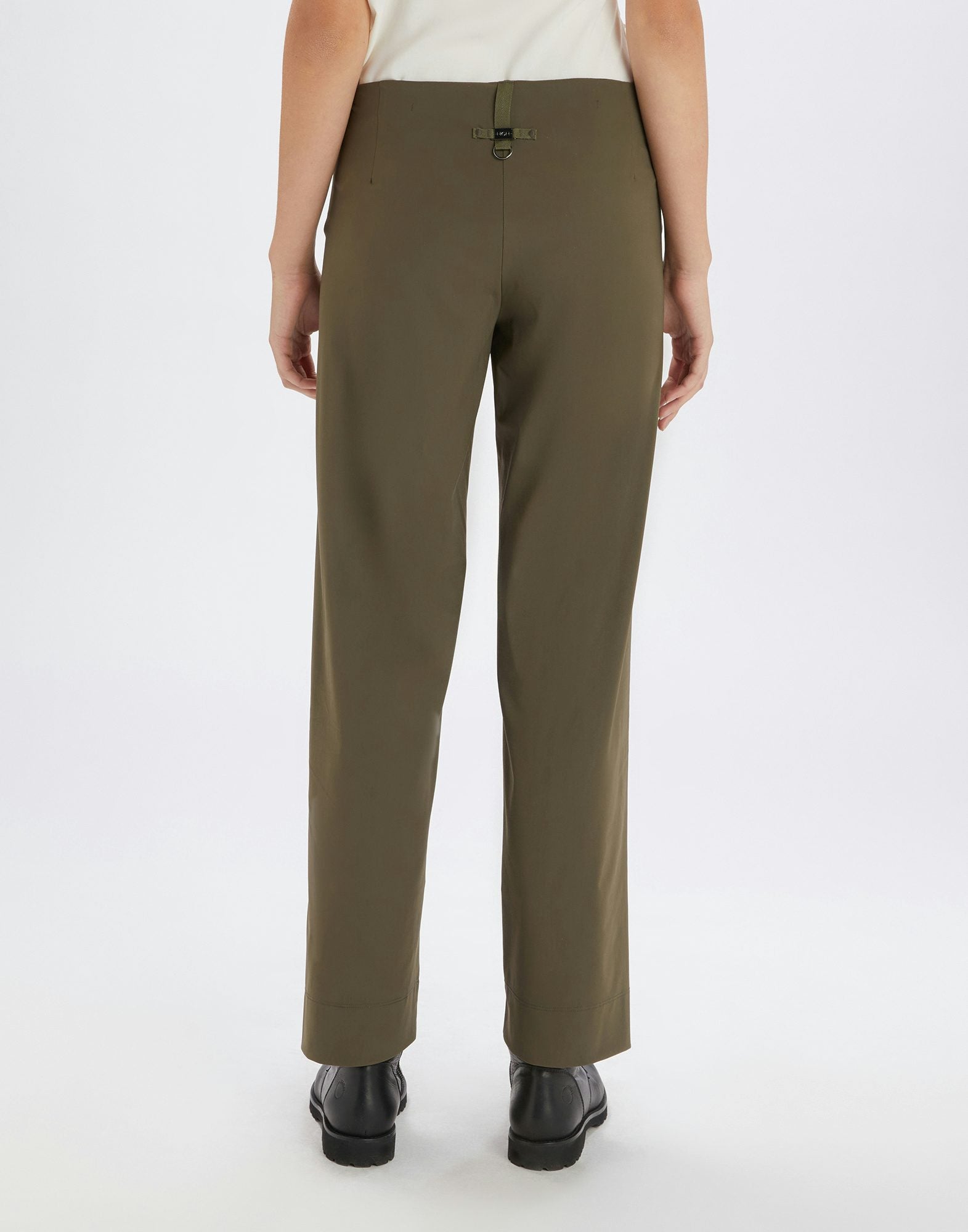 Person wearing olive green pants on a white background