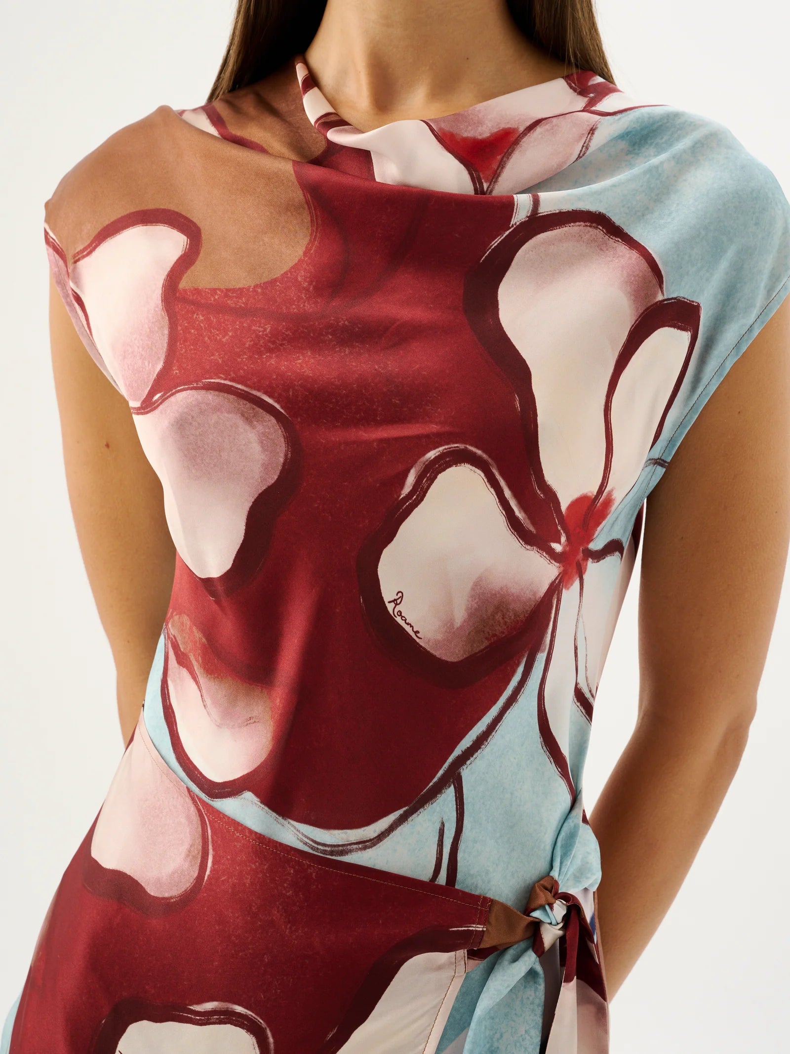 Colorful floral scarf with a tie on a plain background