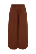 A pair of wide-leg cropped pants in a solid rust brown color, featuring an elastic waistband, shown against a plain white background.