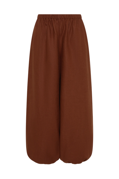 A pair of wide-leg cropped pants in a solid rust brown color, featuring an elastic waistband, shown against a plain white background.