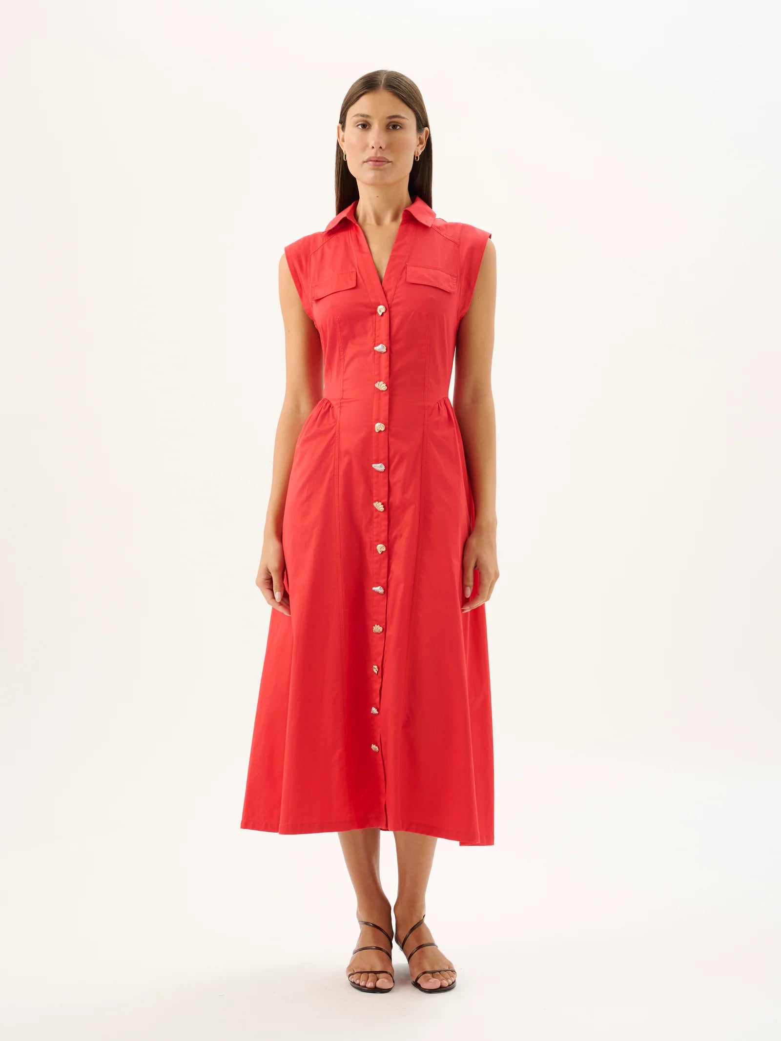 Woman wearing a red sleeveless dress on a white background