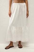 White tiered skirt worn by a person on a white background