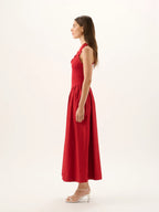 Woman wearing a red dress on a white background