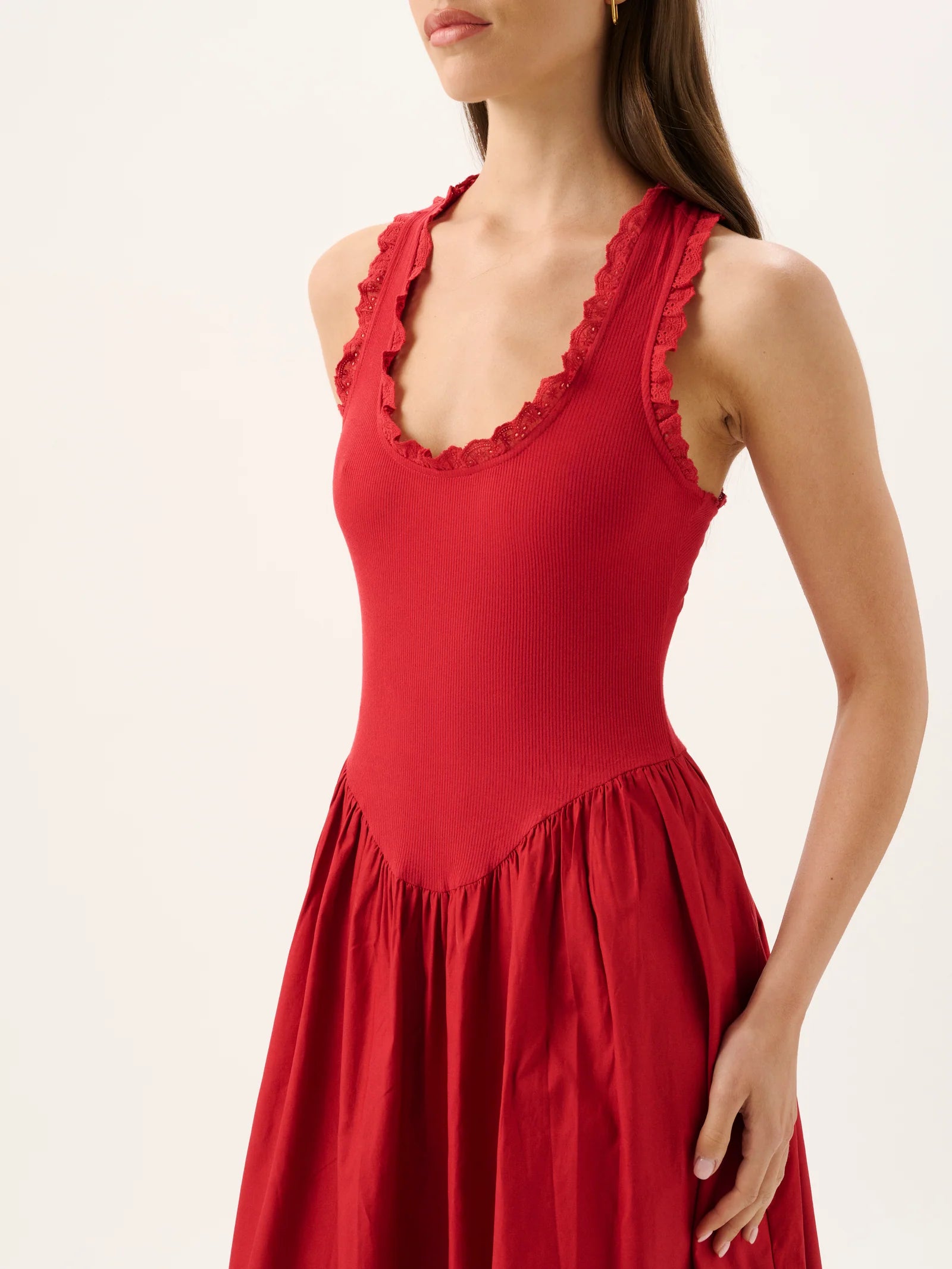 Red dress with lace details on a white background
