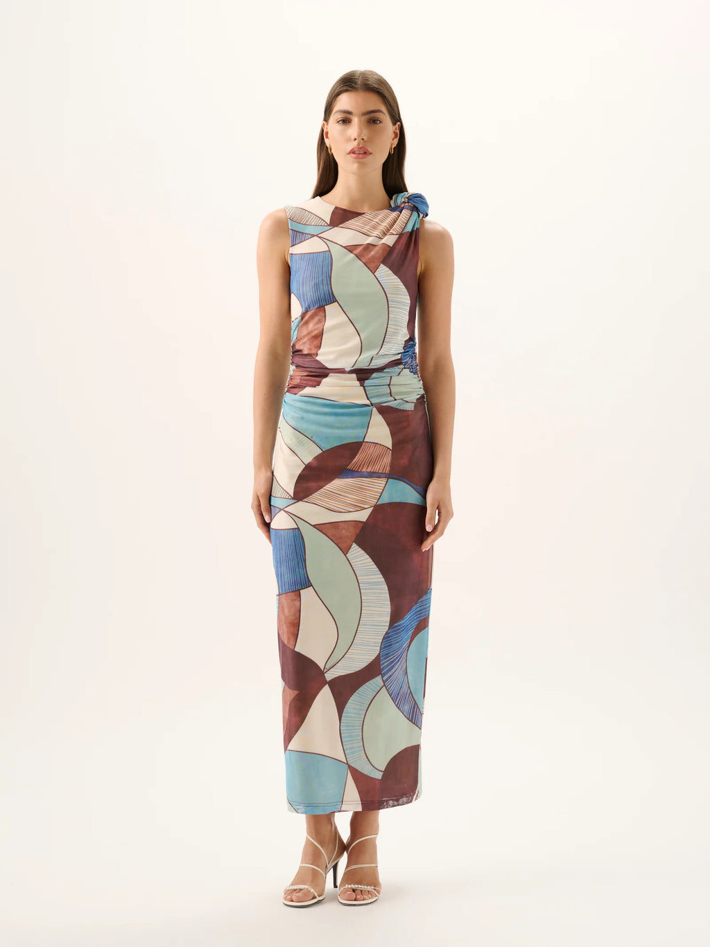 Woman wearing a patterned dress on a white background