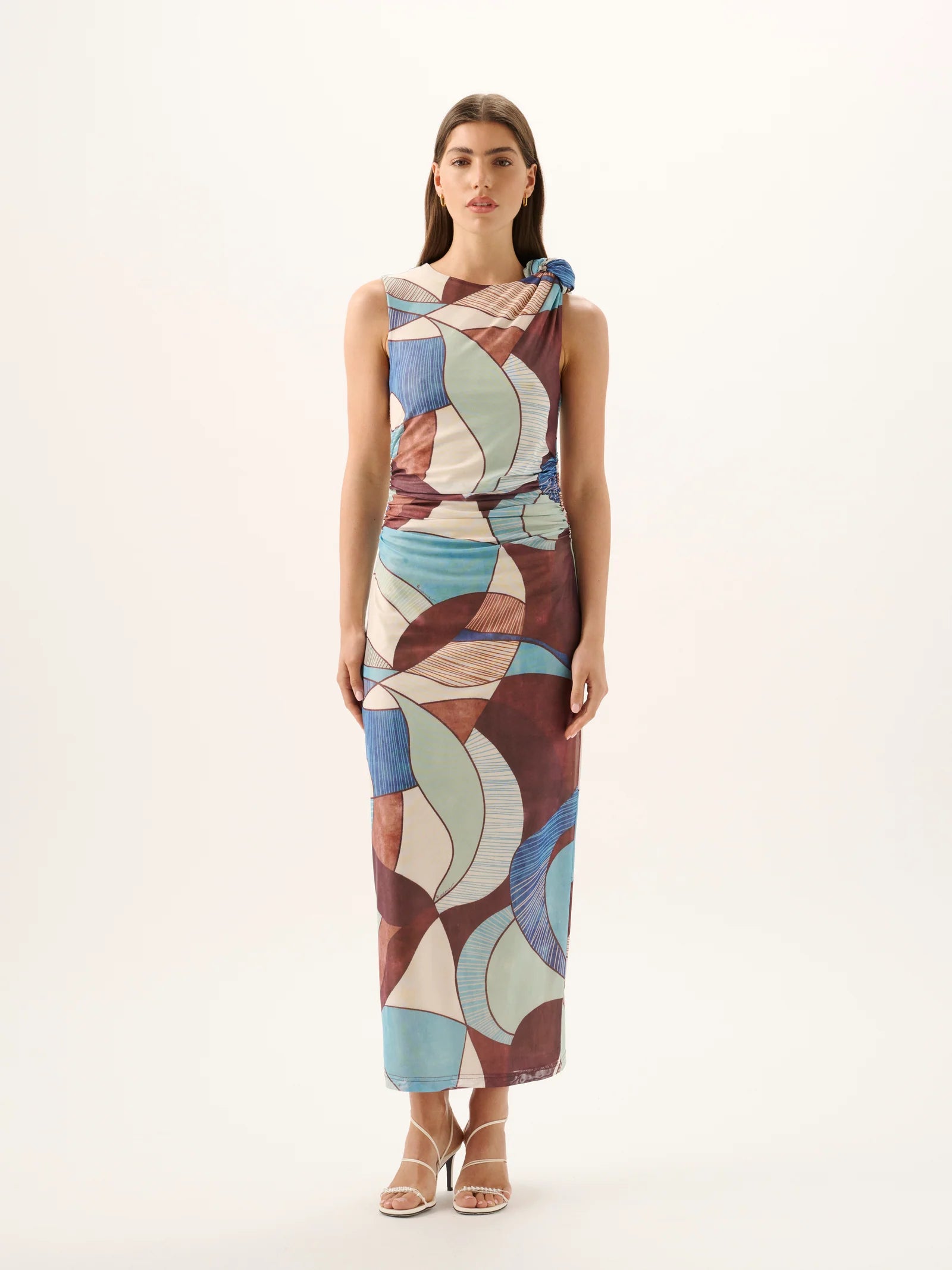 Woman wearing a patterned dress on a white background