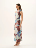 Woman wearing a colorful patterned dress on a white background