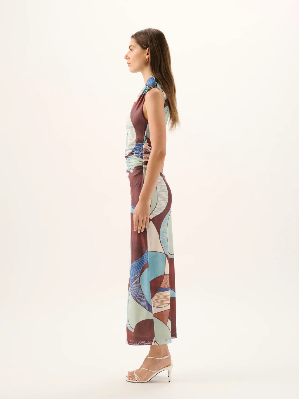 Woman wearing a patterned dress on a white background