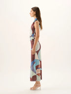 Woman wearing a patterned dress on a white background