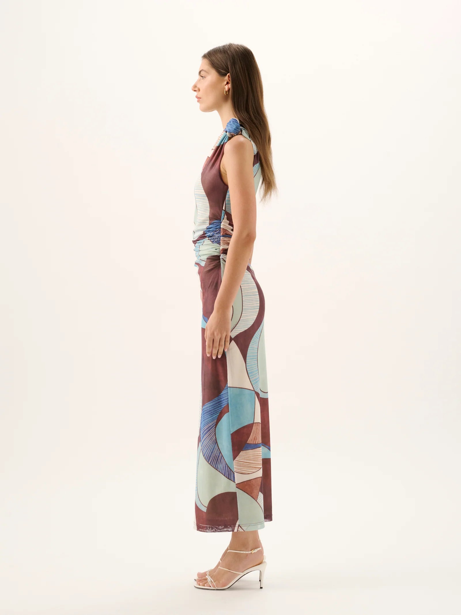 Woman wearing a patterned dress on a white background