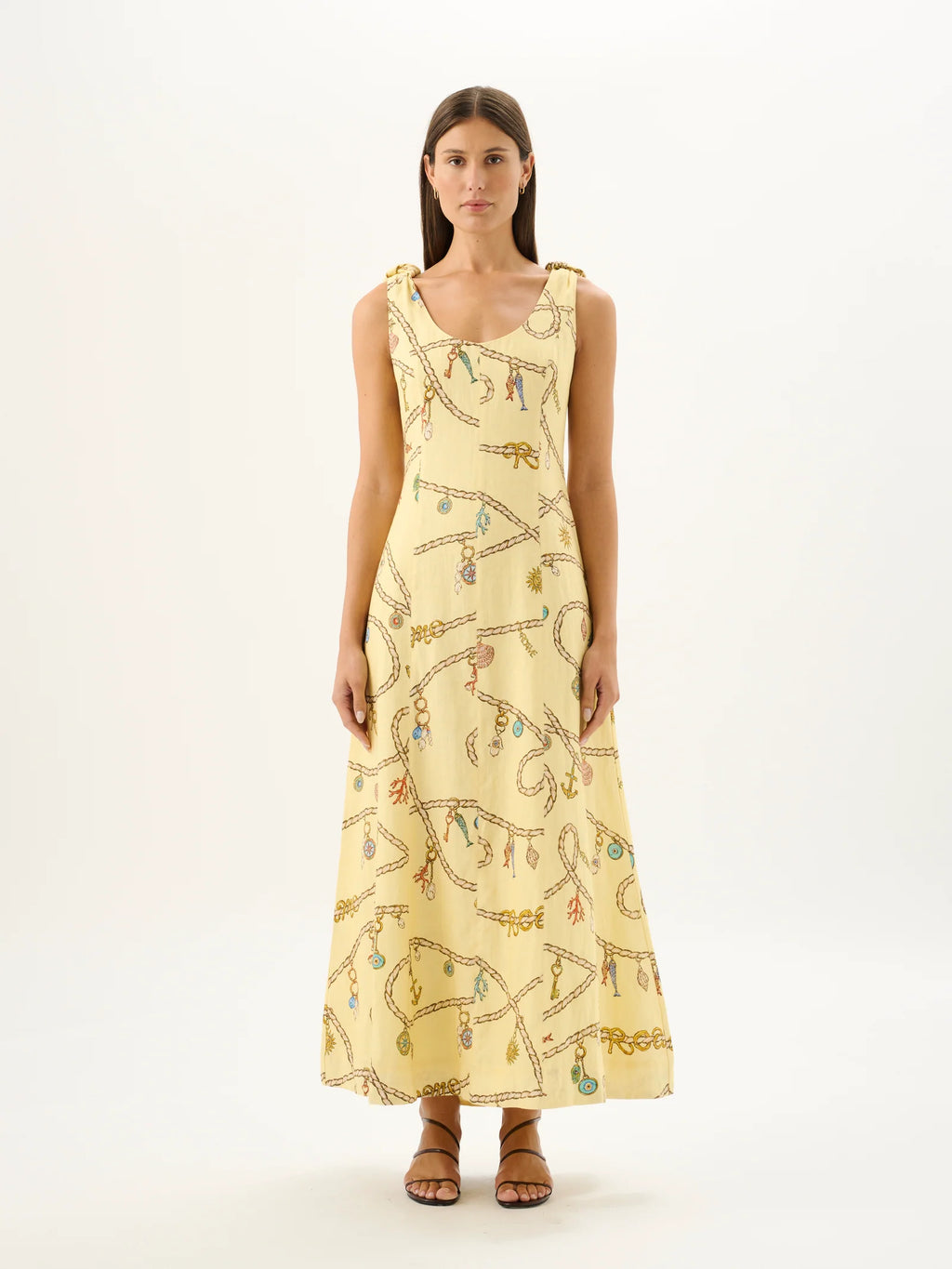 Woman wearing a yellow dress with a pattern on a white background