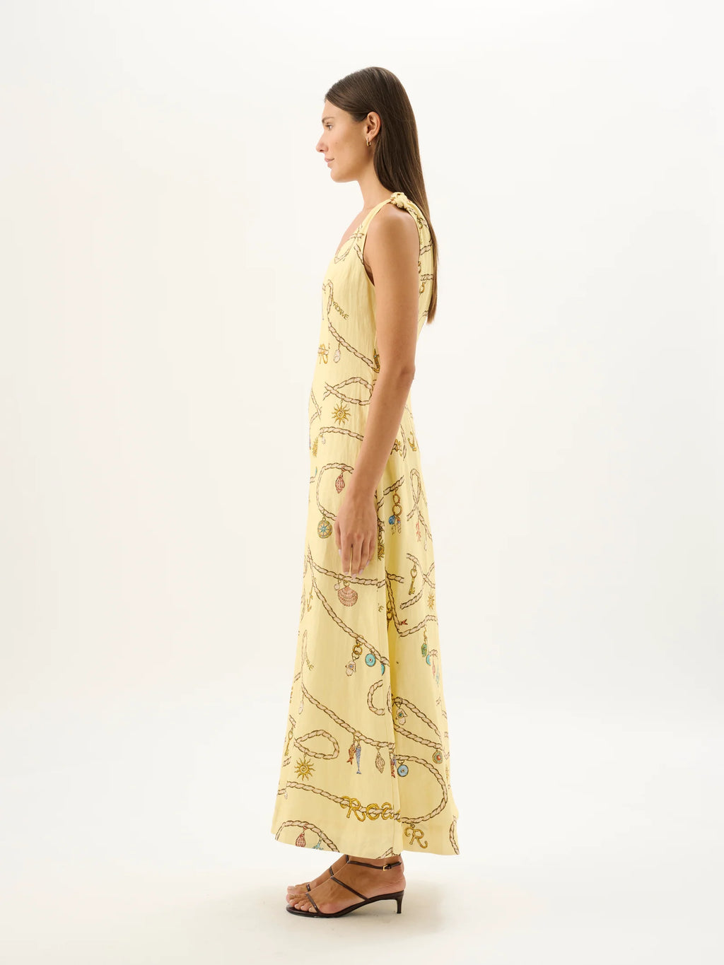 Woman wearing a yellow patterned dress on a white background