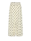 A pair of wide-leg cropped pants in a cream-colored fabric with a black polka dot pattern, shown against a light gray background.