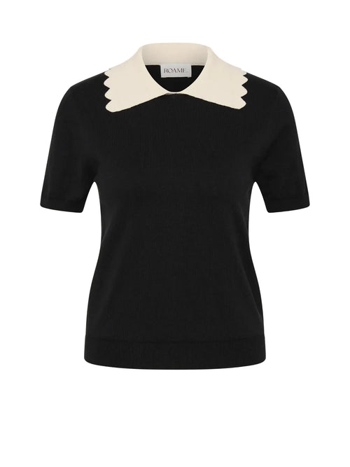 A black short-sleeve knit top with a contrasting cream-colored pointed collar, shown on a light gray background.