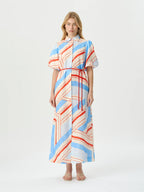 A woman modeling a short-sleeved midi dress with a white base and a geometric stripe pattern in light blue and orange-red, featuring a matching red drawstring waist tie, set against a plain white studio background.