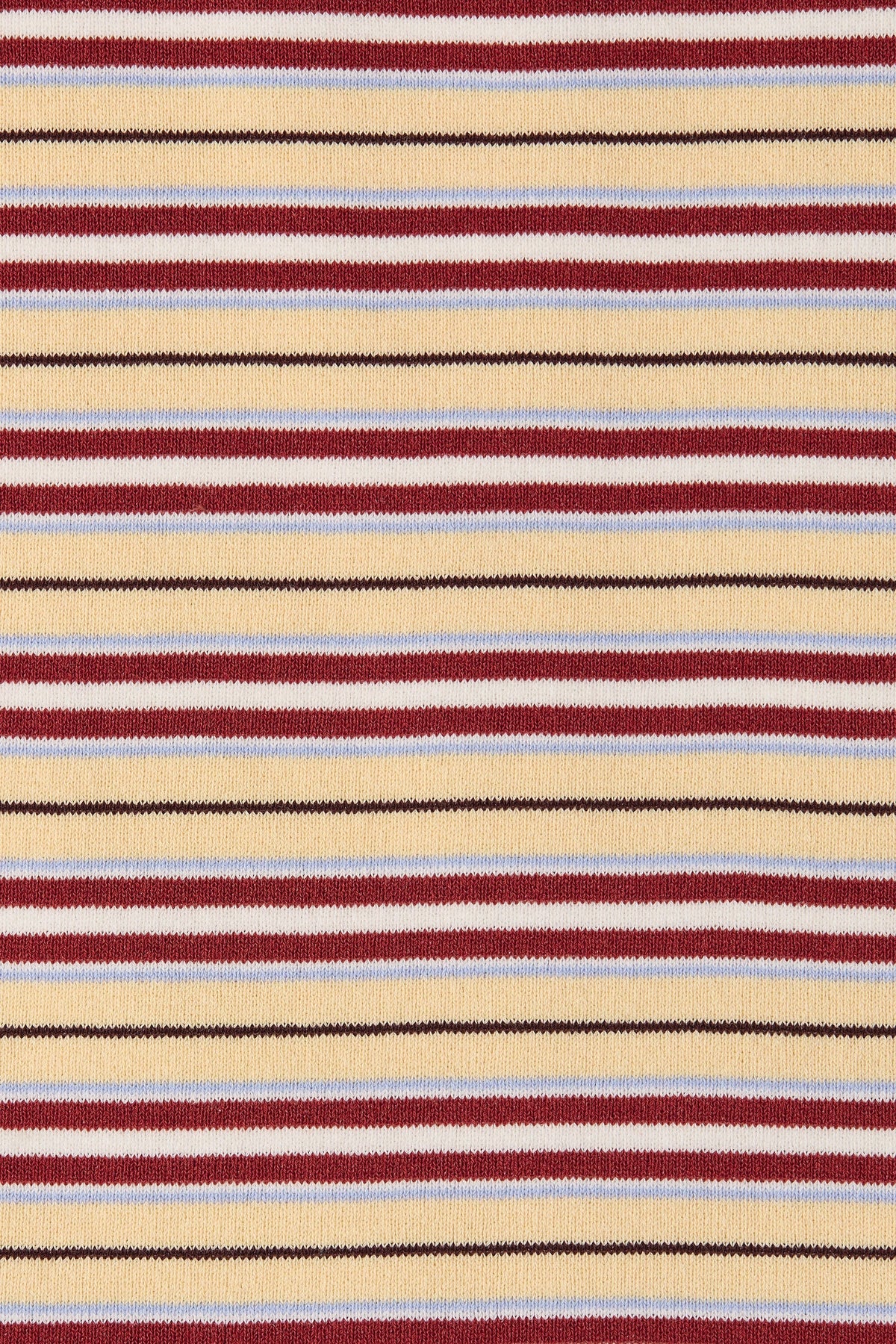 A close-up of a striped knit fabric with horizontal bands of beige, burgundy red, light blue, and thin black lines.